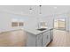 Open-concept kitchen boasts a large center island, stainless appliances, and access to the living area at 7620 W Minton St, Laveen, AZ 85339
