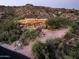 Expansive desert home featuring a pool, lush greenery, and nestled against a mountainous backdrop at 42035 N 113Th Way, Scottsdale, AZ 85262