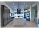 Modern kitchen featuring stainless steel appliances, a marble island, and unique tiled flooring at 42035 N 113Th Way, Scottsdale, AZ 85262