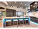 A modern kitchen with an island with seating and stylish pendant lighting at 42035 N 113Th Way, Scottsdale, AZ 85262