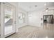 Bright dining area featuring tile floors, modern lighting, and a door leading to the outdoors at 901 S Smith Rd # 1012, Tempe, AZ 85281