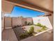 Private backyard with gravel landscaping and a gated entrance at 12873 N 99Th Dr, Sun City, AZ 85351