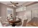 Elegant dining room with a round wooden table and white upholstered chairs at 12873 N 99Th Dr, Sun City, AZ 85351