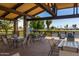 Covered patio with tables and chairs overlooking a lake at 17200 W Bell Rd # 1743, Surprise, AZ 85374