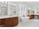 Elegant bathroom with double sinks, soaking tub, and marble floors at 691 E Elgin St, Gilbert, AZ 85295