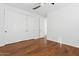 Bedroom with hardwood floors, large closet, and ceiling fan at 691 E Elgin St, Gilbert, AZ 85295