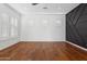 Bright living room featuring hardwood floors and a statement wall at 691 E Elgin St, Gilbert, AZ 85295