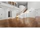 High-ceilinged living room with hardwood floors and a curved staircase at 691 E Elgin St, Gilbert, AZ 85295