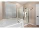 Bathroom features a soaking tub, glass-enclosed shower, and natural light at 2140 W Clearview Trl, Anthem, AZ 85086