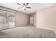 Spacious bedroom with carpet, large window, slider to covered patio, and closet at 2140 W Clearview Trl, Anthem, AZ 85086