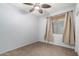 Cozy bedroom featuring neutral walls, carpet, ceiling fan, and a window at 2140 W Clearview Trl, Anthem, AZ 85086