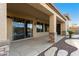 Covered patio with decorative stone columns, landscaped area and view of the backyard at 2140 W Clearview Trl, Anthem, AZ 85086