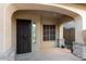 Inviting front porch with stone accents and covered entryway, providing a charming welcome at 2140 W Clearview Trl, Anthem, AZ 85086