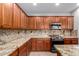 Modern kitchen featuring granite countertops, stainless steel appliances, and ample wood cabinet storage at 2140 W Clearview Trl, Anthem, AZ 85086