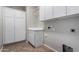 Functional laundry room with ample storage and tile flooring at 2140 W Clearview Trl, Anthem, AZ 85086