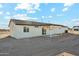 View of the rear of the home with a covered patio and minimal landscaping at 31812 N 221St Dr, Wittmann, AZ 85361