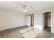 Bedroom with wood-look tile flooring and a barn door leading to the bathroom at 31812 N 221St Dr, Wittmann, AZ 85361