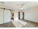 Bedroom with a barn door for privacy and closet access at 31812 N 221St Dr, Wittmann, AZ 85361