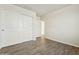 A bedroom features plank flooring and closet with sliding doors at 31812 N 221St Dr, Wittmann, AZ 85361