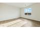 A bedroom with plank flooring and window overlooking blue skies at 31812 N 221St Dr, Wittmann, AZ 85361