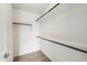 A walk-in closet features wood grain shelves and plank flooring at 31812 N 221St Dr, Wittmann, AZ 85361