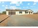 Charming single-story home with a two-car garage, gravel driveway and low-maintenance landscaping at 31812 N 221St Dr, Wittmann, AZ 85361