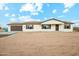 Single-story home with neutral exterior, brown accents, and low-maintenance landscaping offers a welcoming curb appeal at 31812 N 221St Dr, Wittmann, AZ 85361