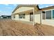 Inviting front porch area leading to the entry door with decorative shutters at 31812 N 221St Dr, Wittmann, AZ 85361