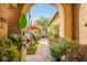 Landscaped backyard oasis with archway entry at 40903 N Harbour Town Way, Anthem, AZ 85086