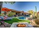 Resort-style backyard with pool, spa, fire pit, and lounge area at 40903 N Harbour Town Way, Anthem, AZ 85086