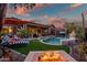 Luxury backyard with a pool and fire pit, perfect for entertaining at 40903 N Harbour Town Way, Anthem, AZ 85086