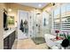 Luxurious bathroom with marble finishes, soaking tub, walk-in shower, and dual vanities at 40903 N Harbour Town Way, Anthem, AZ 85086