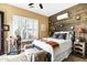 Bright bedroom featuring a wood accent wall, plantation shutters, and stylish Southwestern decor at 40903 N Harbour Town Way, Anthem, AZ 85086