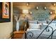 Close-up of a bedroom with wood wall accents and an ornate bed frame at 40903 N Harbour Town Way, Anthem, AZ 85086