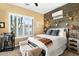 Bedroom with rustic wood wall and cozy bedding at 40903 N Harbour Town Way, Anthem, AZ 85086