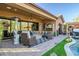 Spacious covered patio with seating area and fire pit at 40903 N Harbour Town Way, Anthem, AZ 85086