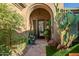 Elegant entryway with arched doorway and landscaping at 40903 N Harbour Town Way, Anthem, AZ 85086