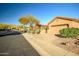 Tan house with desert landscaping and two-car garage at 40903 N Harbour Town Way, Anthem, AZ 85086