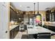 Modern kitchen with dark cabinetry, marble countertops, and a large island at 40903 N Harbour Town Way, Anthem, AZ 85086