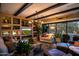 Living room with exposed beams, built-in shelving, and fireplace at 40903 N Harbour Town Way, Anthem, AZ 85086