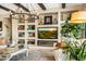 Living room featuring built-in shelving, fireplace, a large flat screen tv, and views of the backyard at 40903 N Harbour Town Way, Anthem, AZ 85086