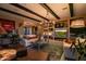 Living room with exposed beams, built-in shelving, and fireplace at 40903 N Harbour Town Way, Anthem, AZ 85086