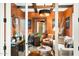 Stylish office with exposed beams, warm colors, and a comfortable seating area for clients at 40903 N Harbour Town Way, Anthem, AZ 85086