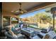 Spacious backyard patio with pool and seating at 40903 N Harbour Town Way, Anthem, AZ 85086