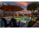 Serene pool with lounge chairs and umbrella at 40903 N Harbour Town Way, Anthem, AZ 85086