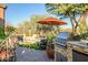 Relaxing poolside patio with built in grill at 40903 N Harbour Town Way, Anthem, AZ 85086