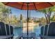 Inviting pool area with two chairs and umbrella for shade at 40903 N Harbour Town Way, Anthem, AZ 85086