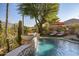 Beautiful pool with a stone fountain and lush landscaping at 40903 N Harbour Town Way, Anthem, AZ 85086