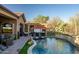 Luxury backyard featuring a pool, hot tub, and pergola at 40903 N Harbour Town Way, Anthem, AZ 85086