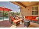 Relaxing covered patio featuring comfortable seating and an umbrella at 183 W Evergreen Pear Ave, Queen Creek, AZ 85140